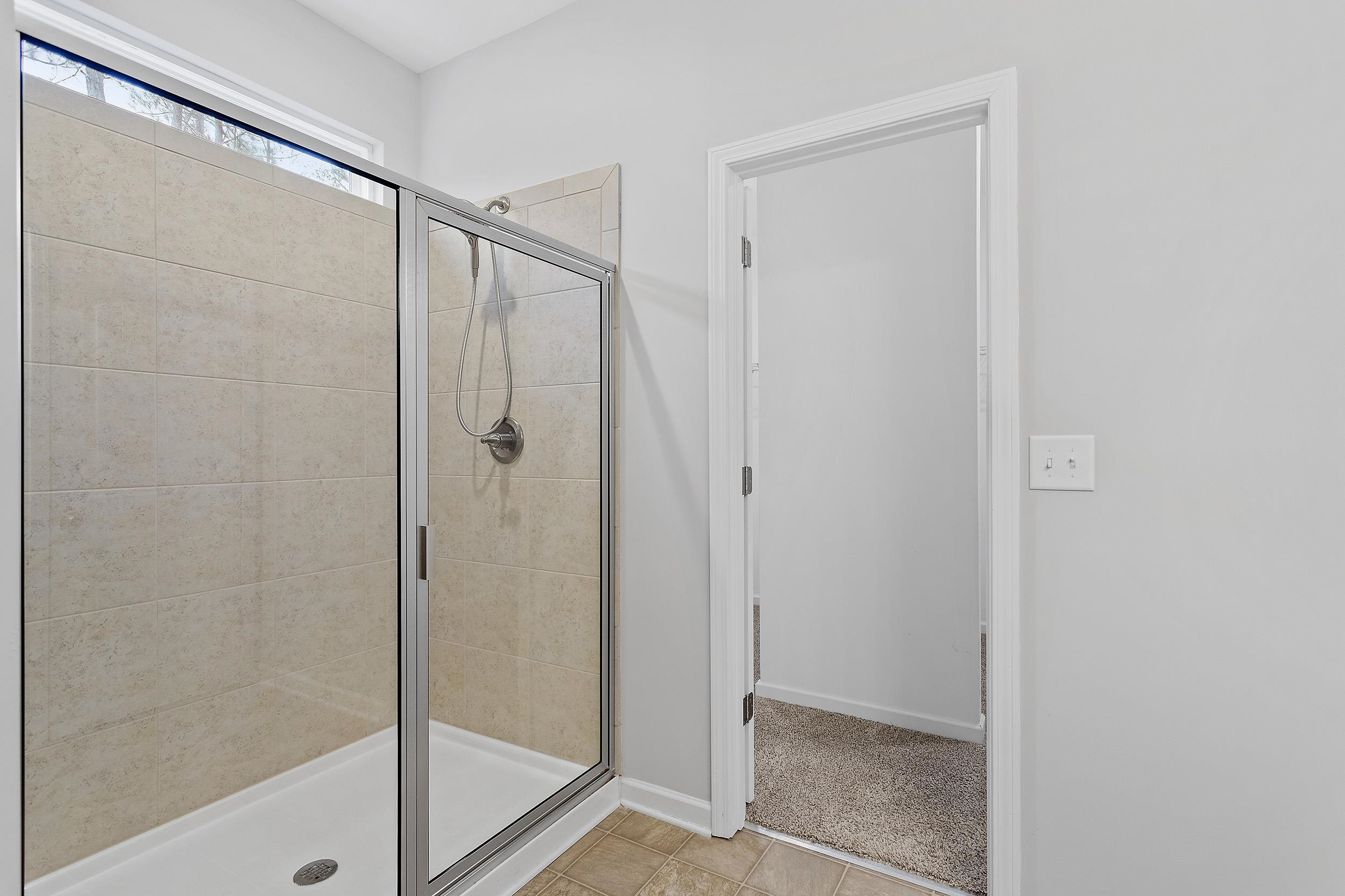 306 Springhill Lane Garner, NC 27529 - Photo 25 of 34 a bathroom with a glass shower door