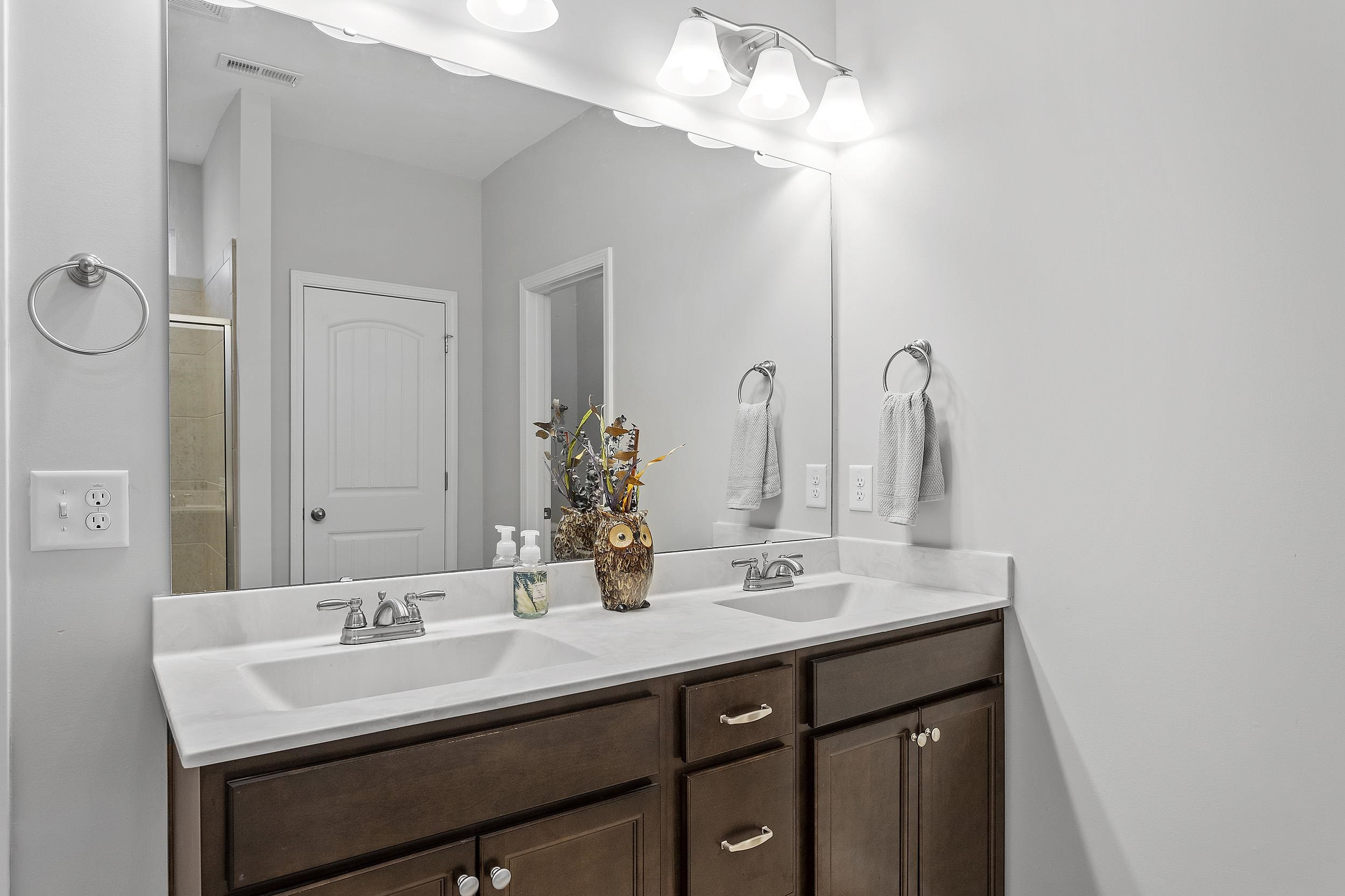 306 Springhill Lane Garner, NC 27529 - Photo 27 of 34 a bathroom with a sink and a mirror