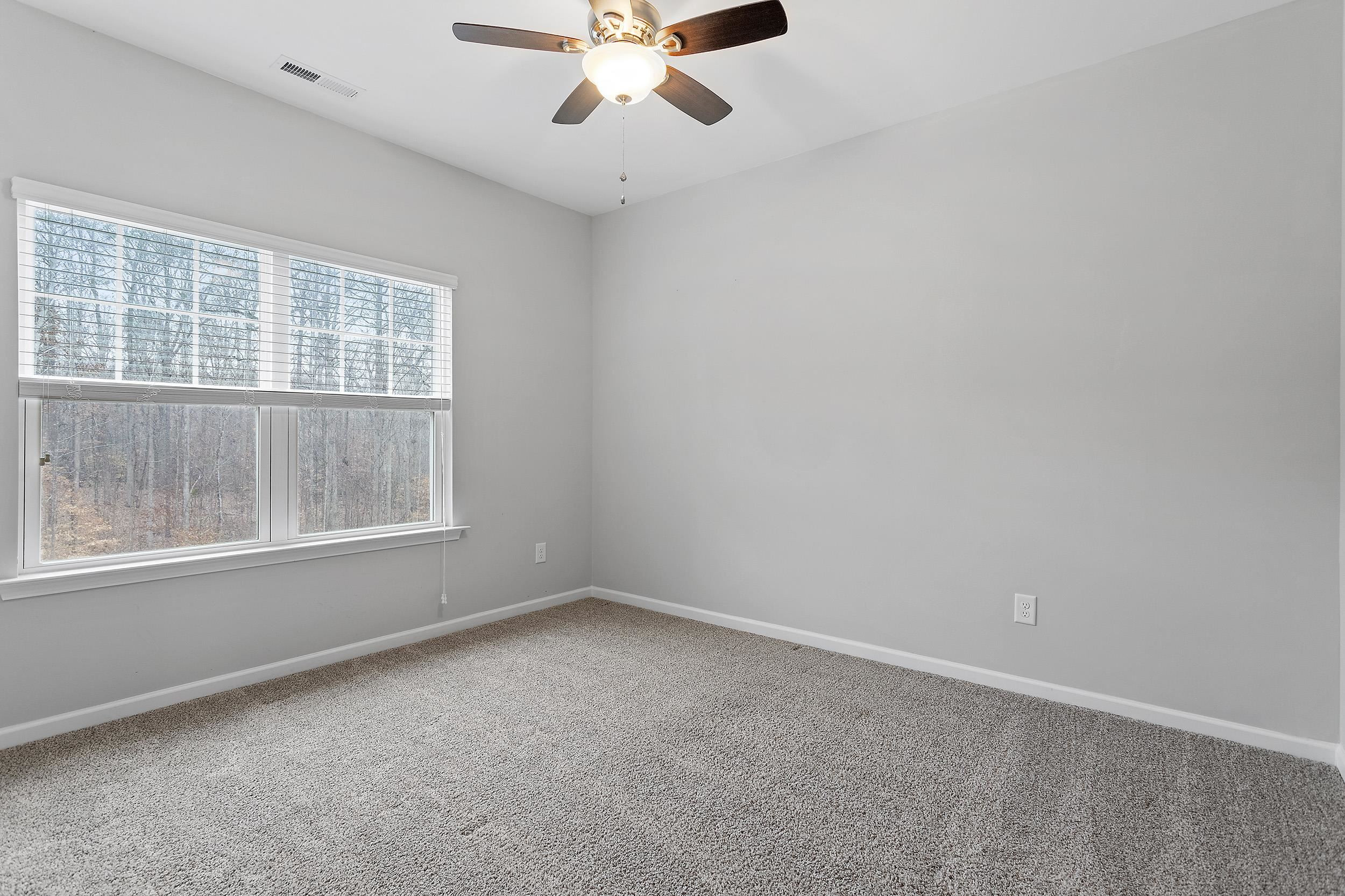 306 Springhill Lane Garner, NC 27529 - Photo 29 of 34 an empty room with a window and a fan
