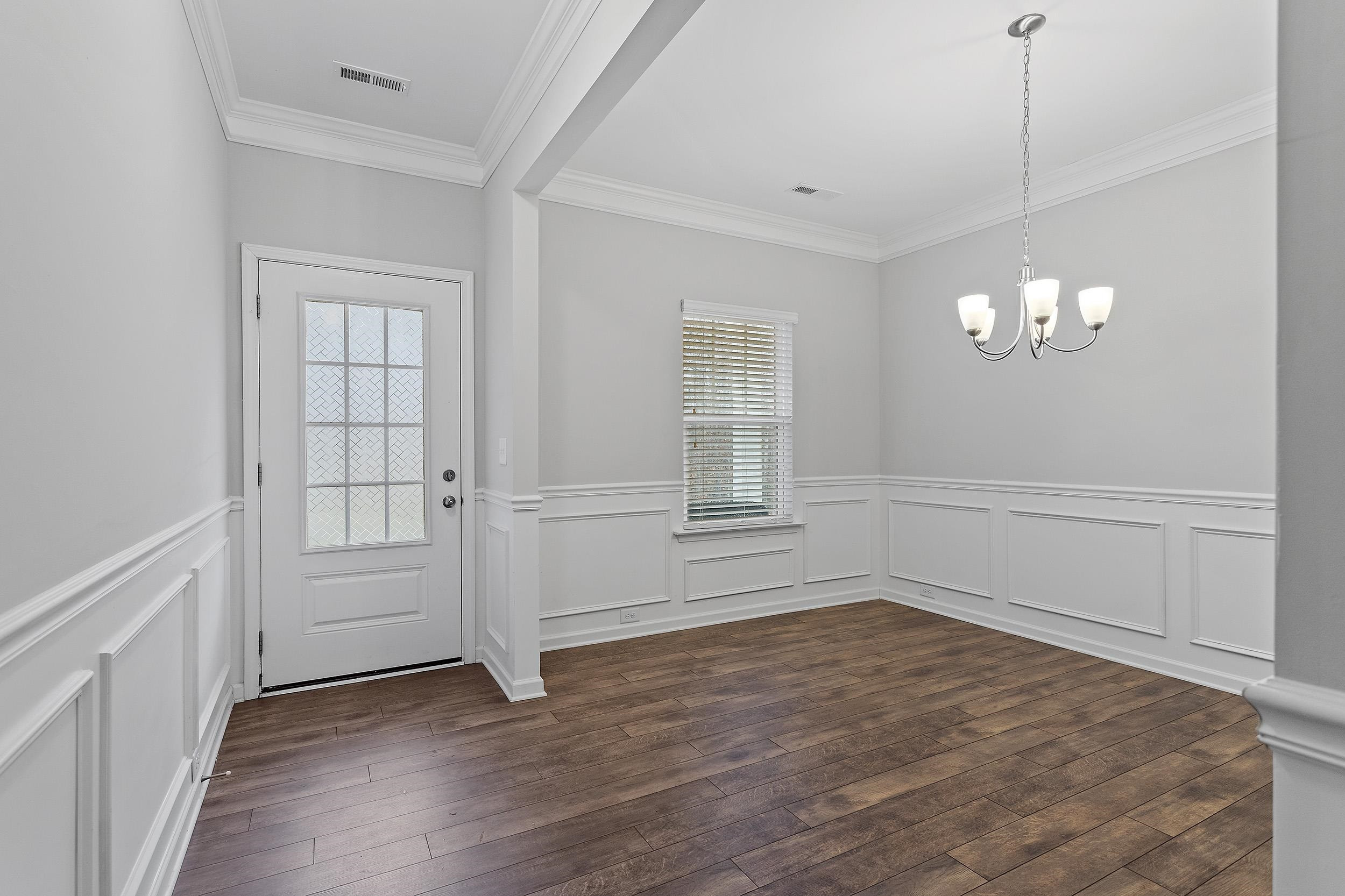 306 Springhill Lane Garner, NC 27529 - Photo 7 of 34 wooden floor in an empty room with a window