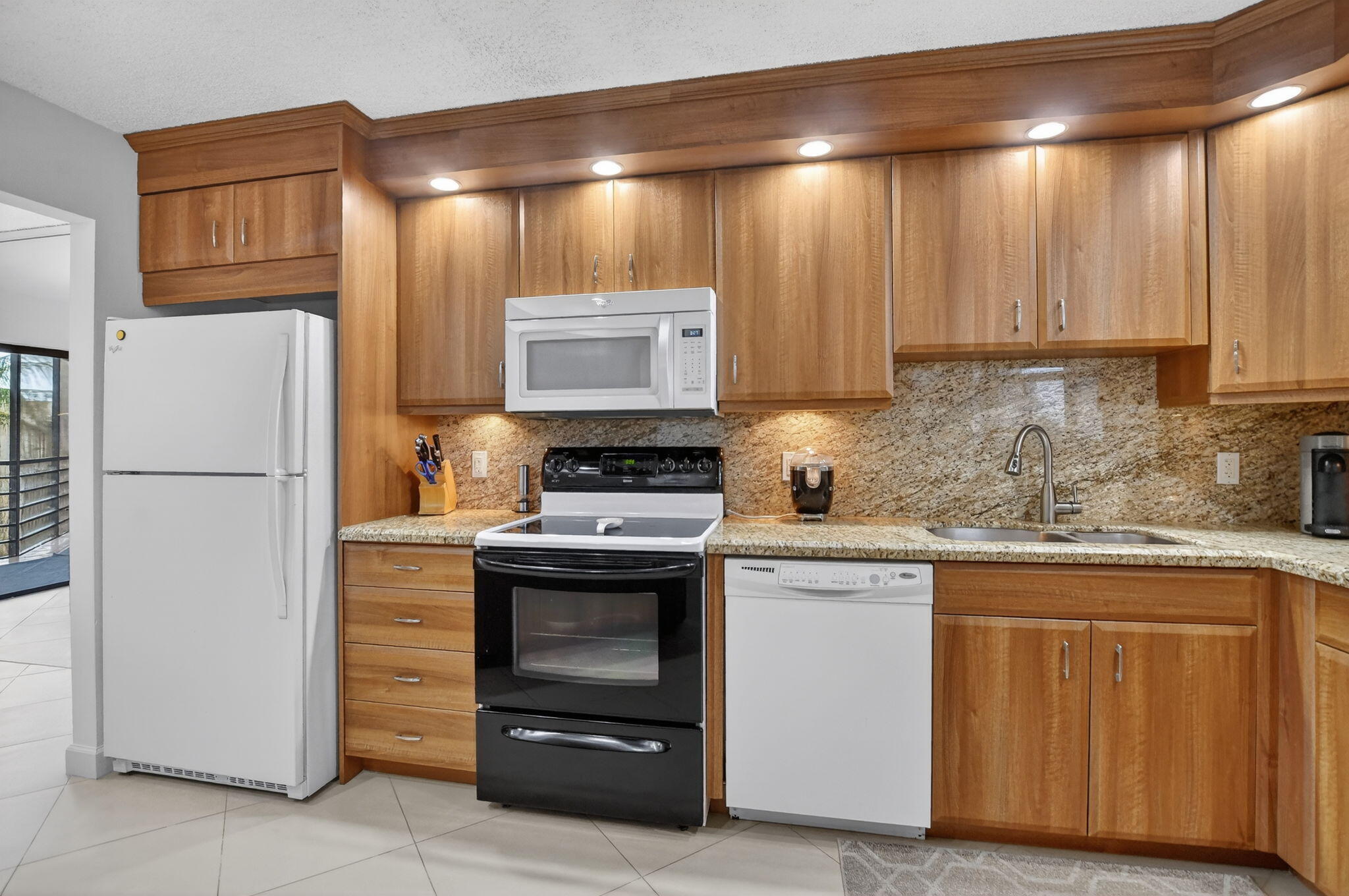 5851 Camino Del Sol, Unit 402 Boca Raton, FL 33433 - Photo 13 of 40 a kitchen with a stove and a refrigerator