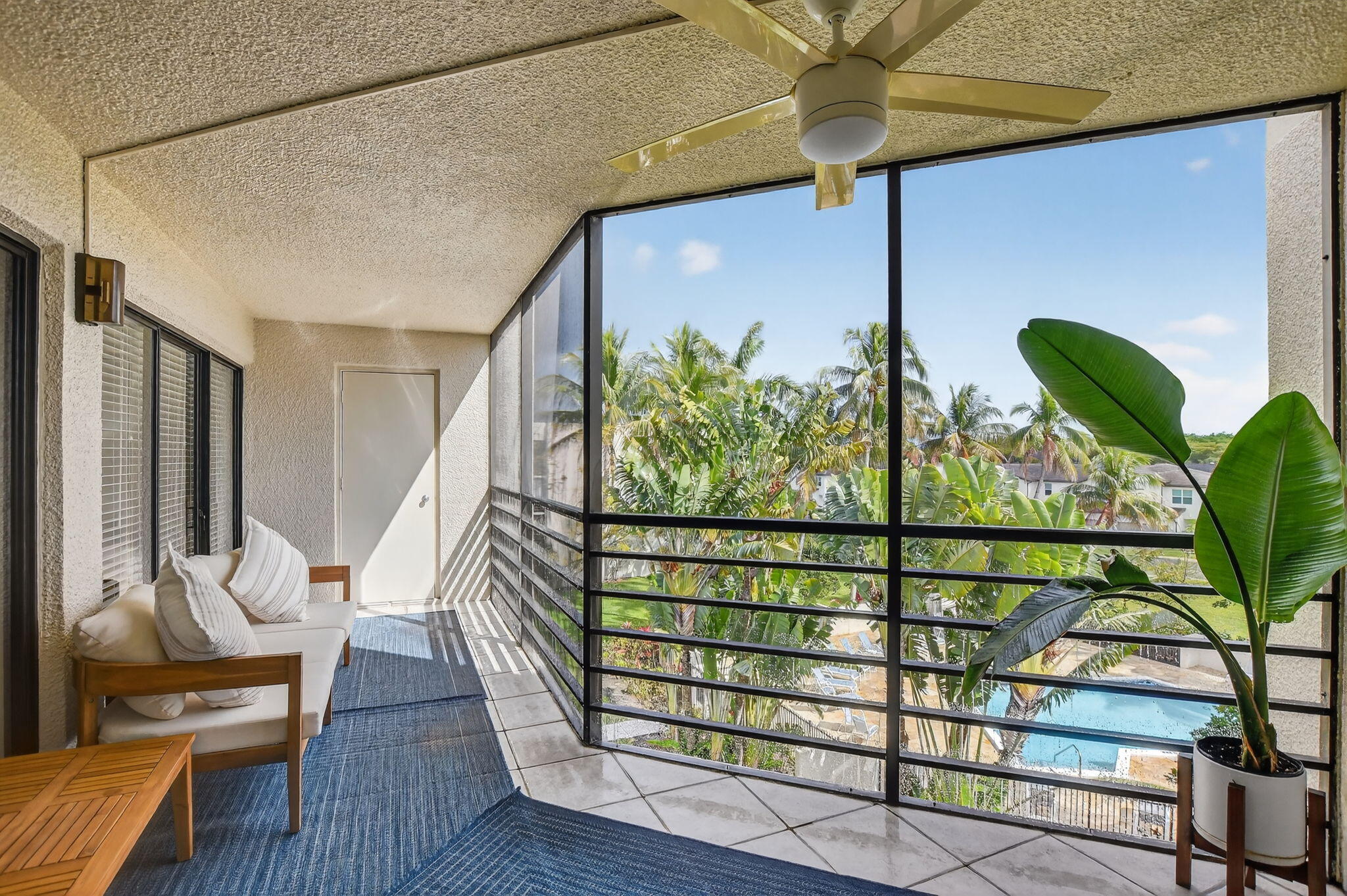 5851 Camino Del Sol, Unit 402 Boca Raton, FL 33433 - Photo 17 of 40 a view of a chairs and table in a balcony