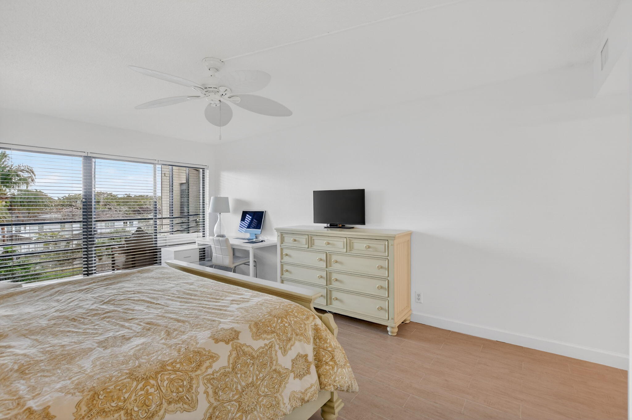 5851 Camino Del Sol, Unit 402 Boca Raton, FL 33433 - Photo 22 of 40 a bedroom with a bed and large window