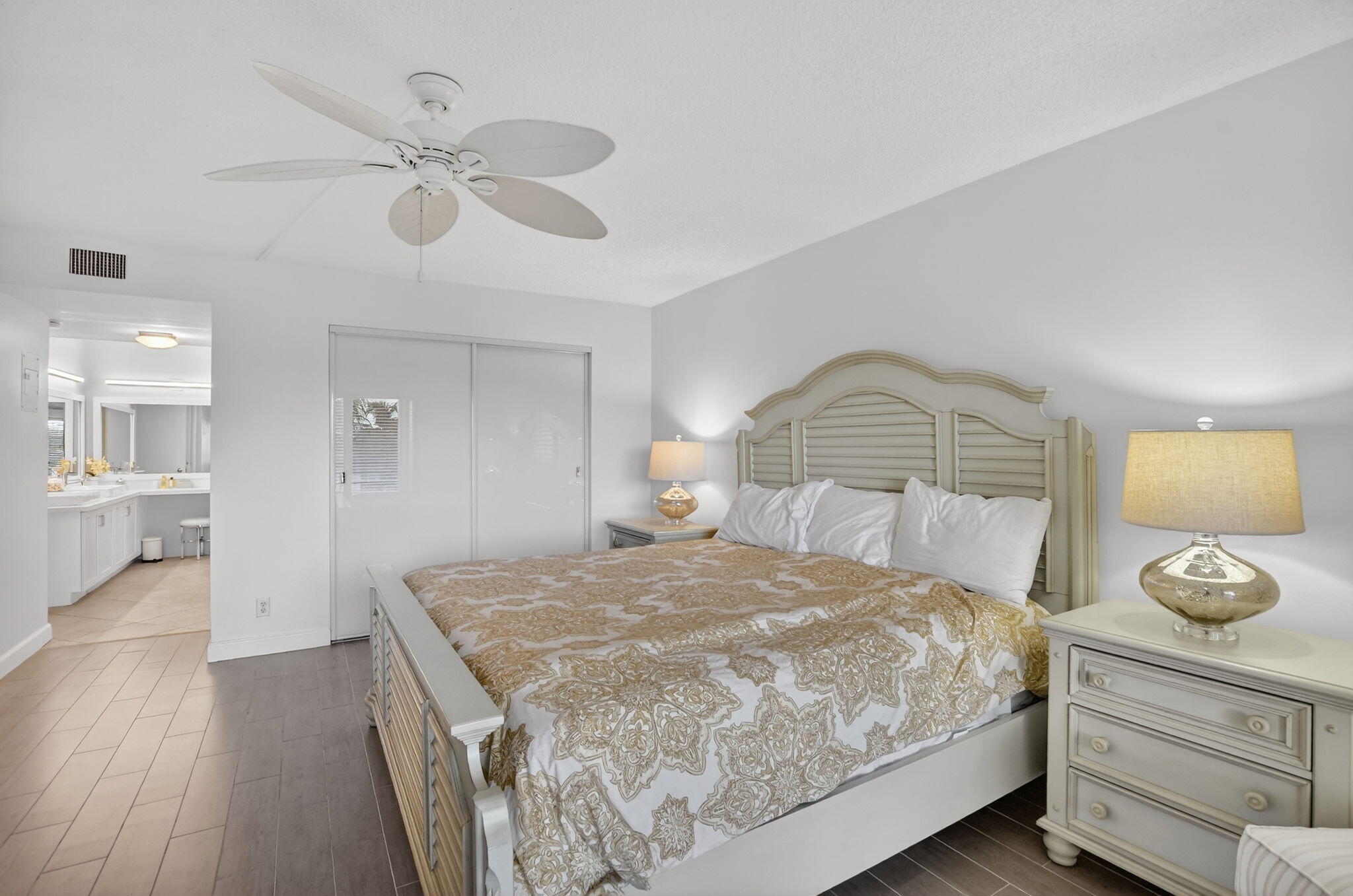 5851 Camino Del Sol, Unit 402 Boca Raton, FL 33433 - Photo 23 of 40 a bedroom with a bed and a chandelier