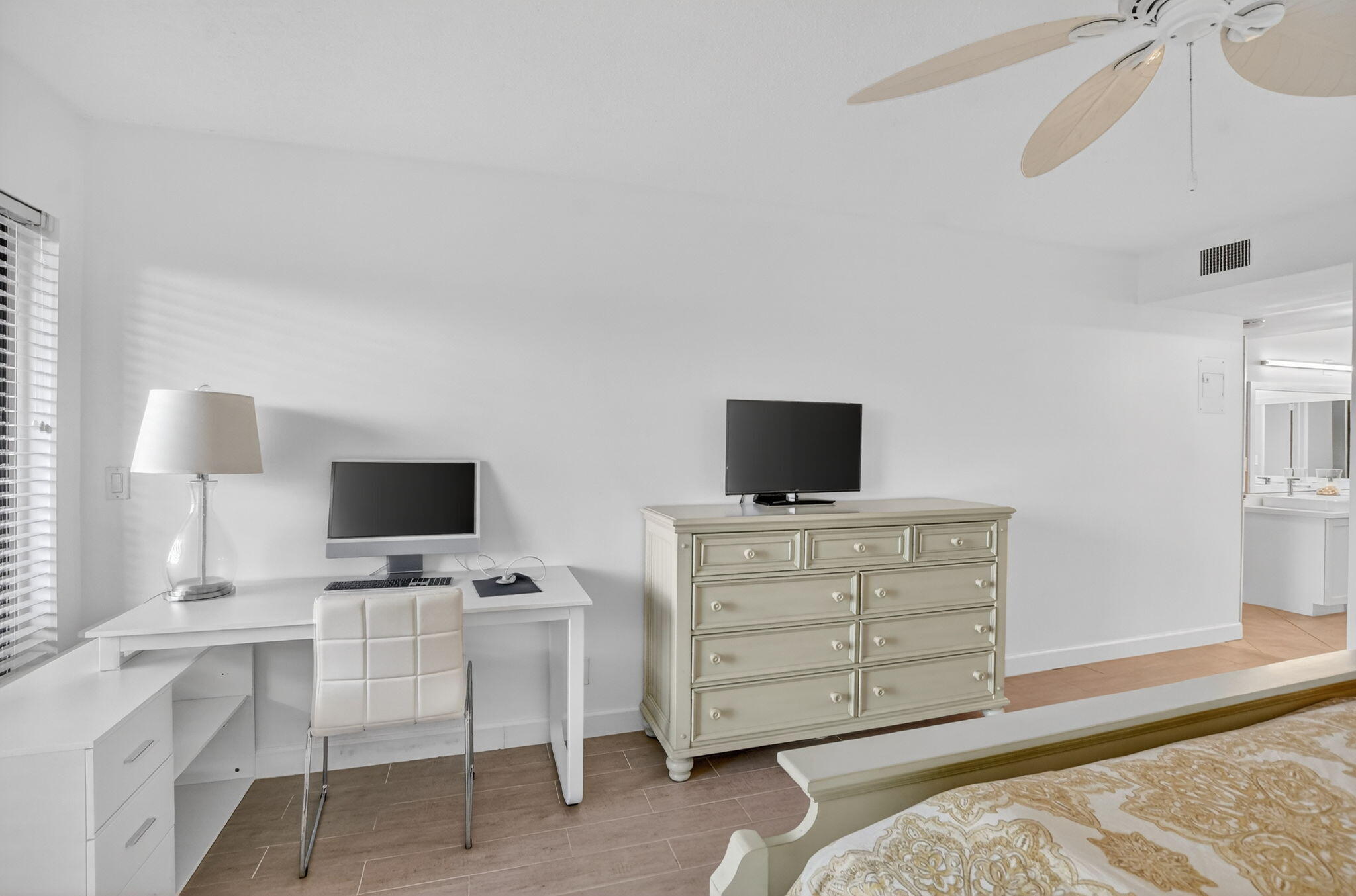 5851 Camino Del Sol, Unit 402 Boca Raton, FL 33433 - Photo 24 of 40 a room with a flat screen tv and a dresser