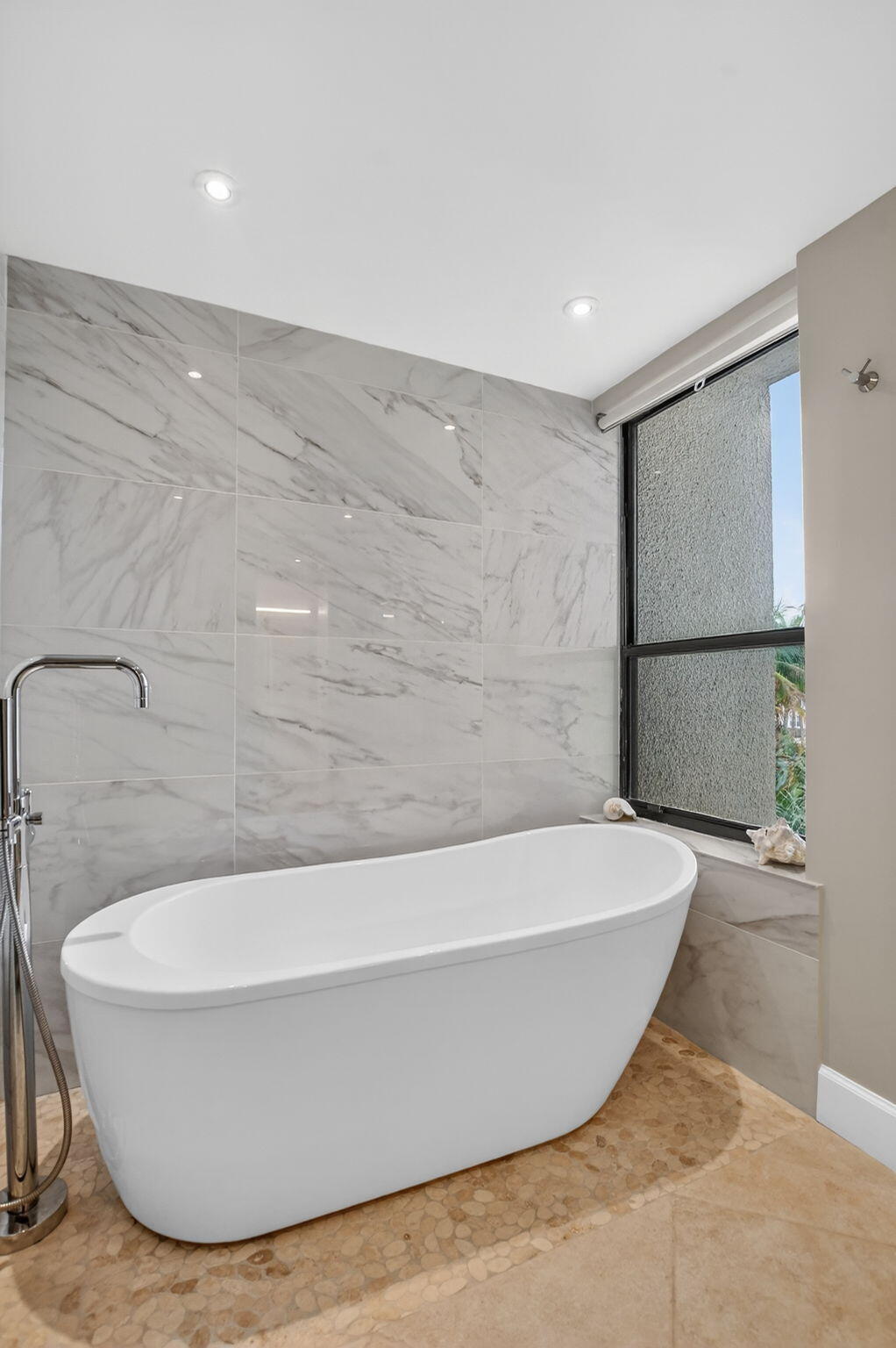 5851 Camino Del Sol, Unit 402 Boca Raton, FL 33433 - Photo 28 of 40 a white tub sitting in a bathroom