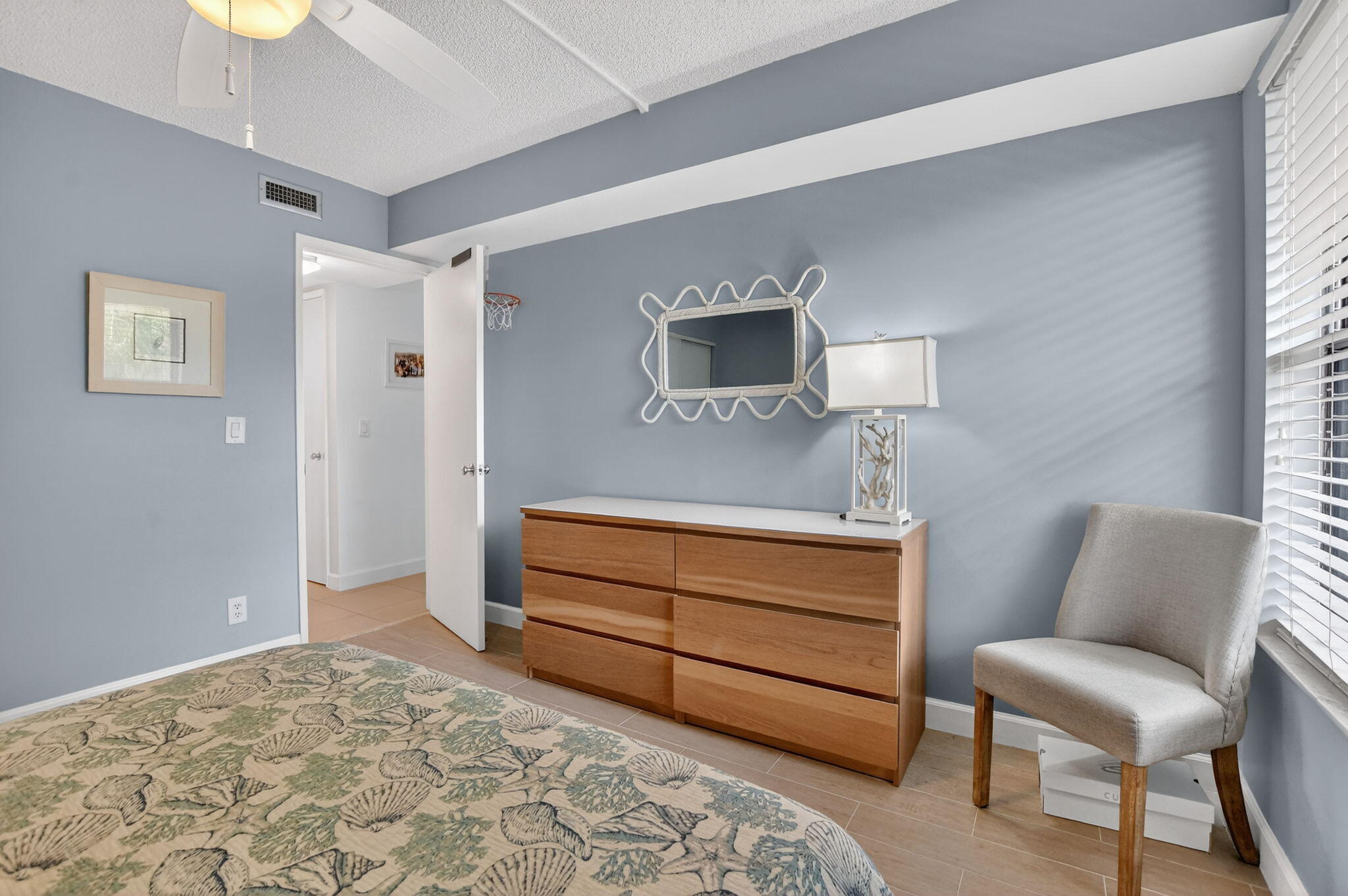 5851 Camino Del Sol, Unit 402 Boca Raton, FL 33433 - Photo 32 of 40 a bedroom with a bed and a chair