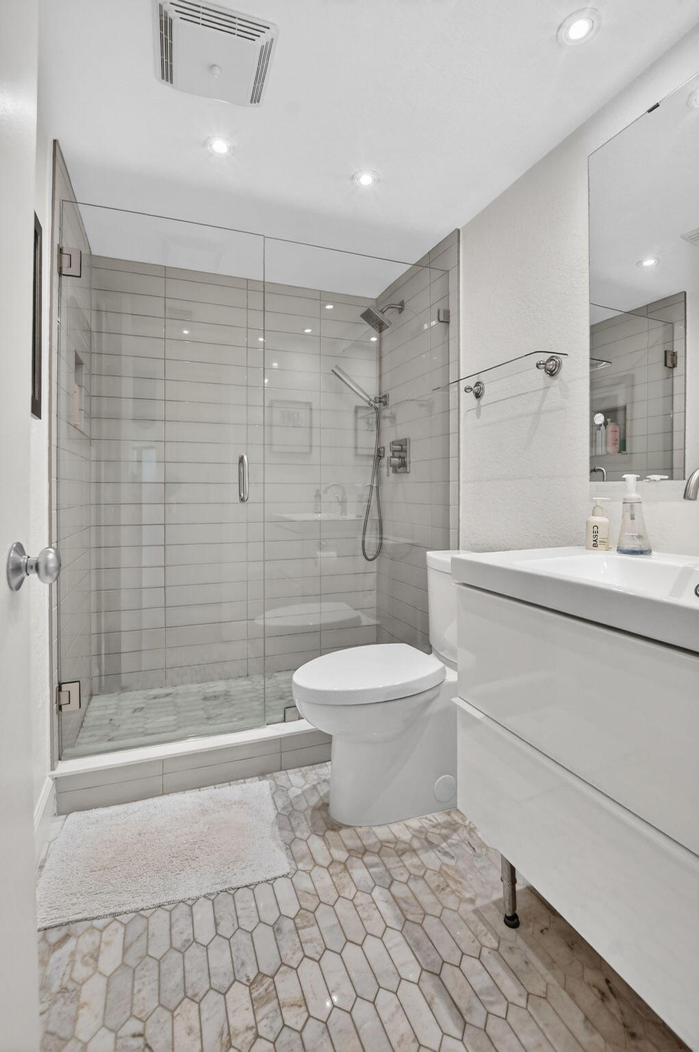 5851 Camino Del Sol, Unit 402 Boca Raton, FL 33433 - Photo 33 of 40 a bathroom with a toilet sink and shower