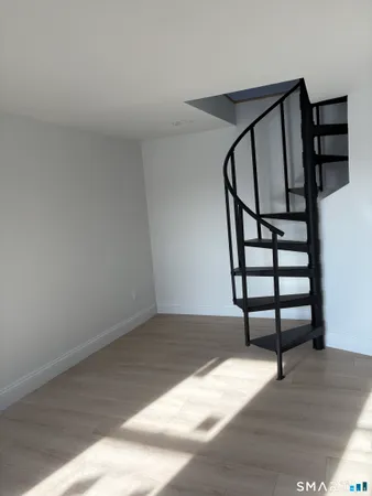 a view of entryway with wooden floor and stairs