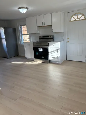 a view of kitchen with sink and cabinets