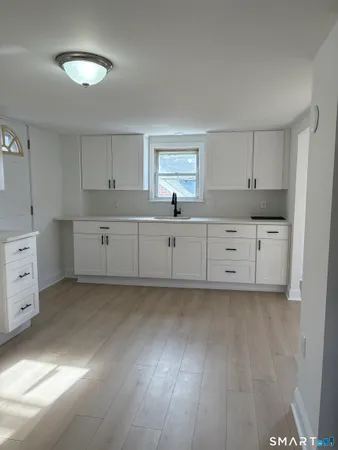 a kitchen with cabinets a sink and dishwasher