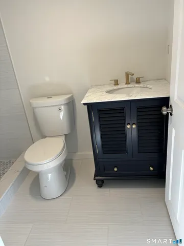 a bathroom with a toilet and a sink