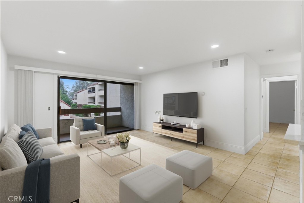 600 West 3rd Street, Unit A210 Santa Ana, CA 92701 - Photo 1 of 30 a living room with furniture and a flat screen tv