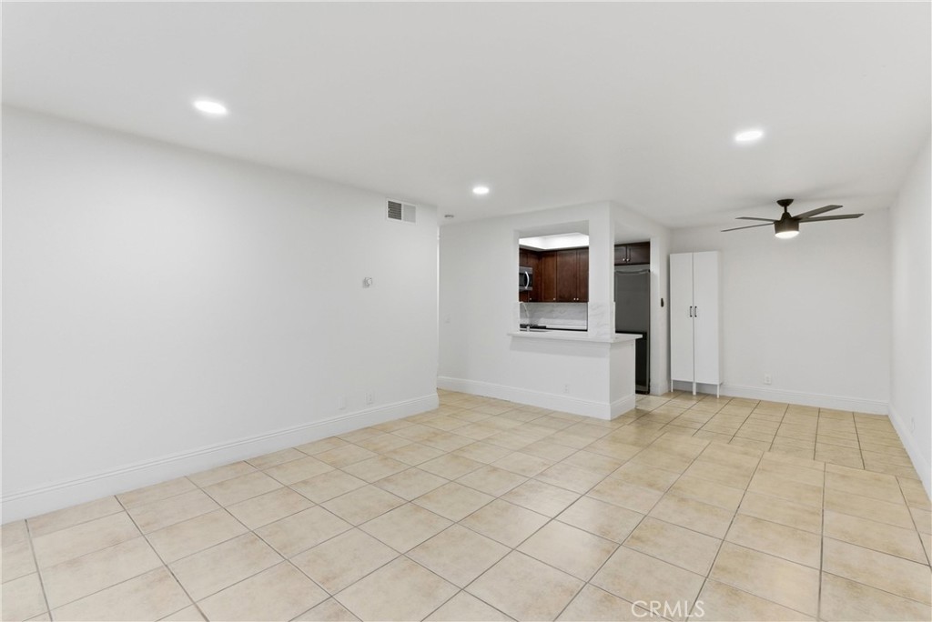 600 West 3rd Street, Unit A210 Santa Ana, CA 92701 - Photo 24 of 30 an empty room with fireplace and tv