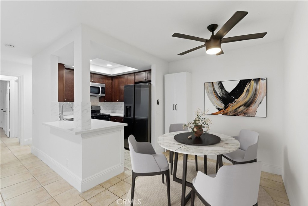 600 West 3rd Street, Unit A210 Santa Ana, CA 92701 - Photo 3 of 30 a kitchen with a table and chairs