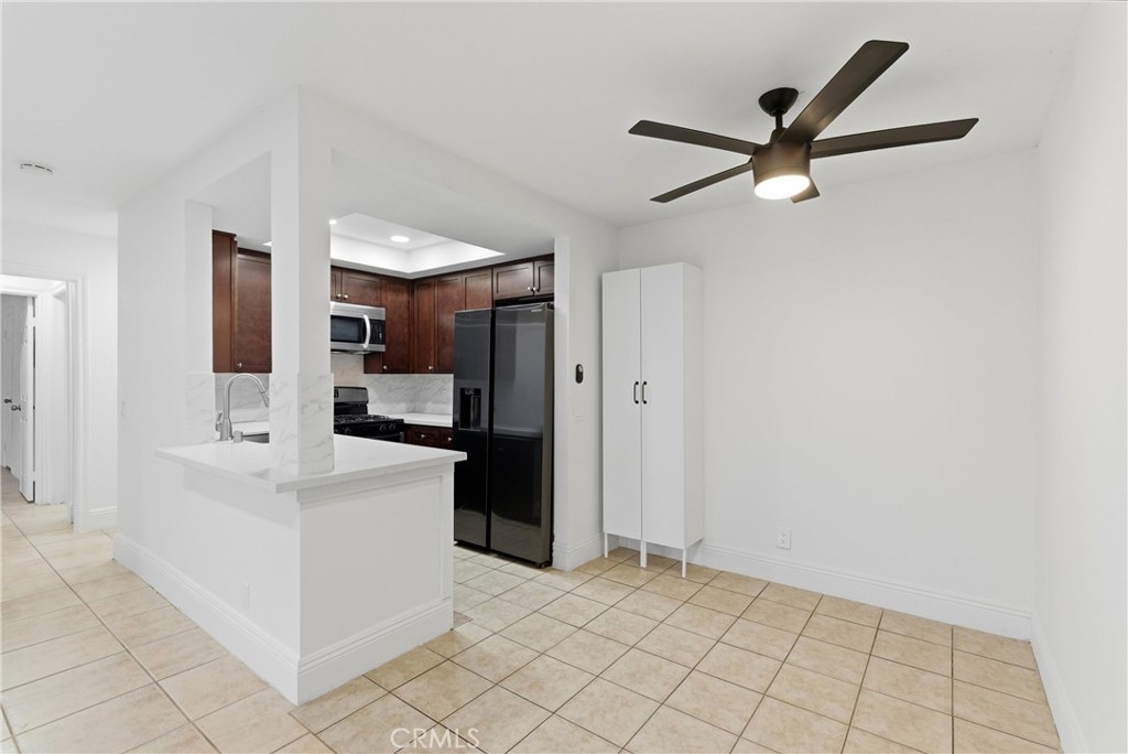 600 West 3rd Street, Unit A210 Santa Ana, CA 92701 - Photo 4 of 30 a view of a kitchen with a sink and a refrigerator
