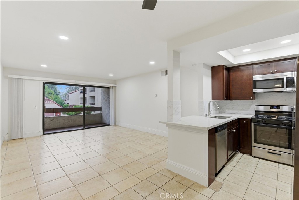 600 West 3rd Street, Unit A210 Santa Ana, CA 92701 - Photo 5 of 30 a view of kitchen with stainless steel appliances granite countertop a stove and a sink