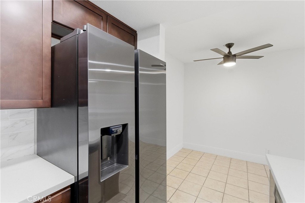600 West 3rd Street, Unit A210 Santa Ana, CA 92701 - Photo 9 of 30 a view of a refrigerator in kitchen and an empty room