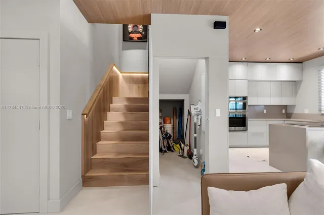 a view of kitchen with stainless steel appliances refrigerator and cabinets