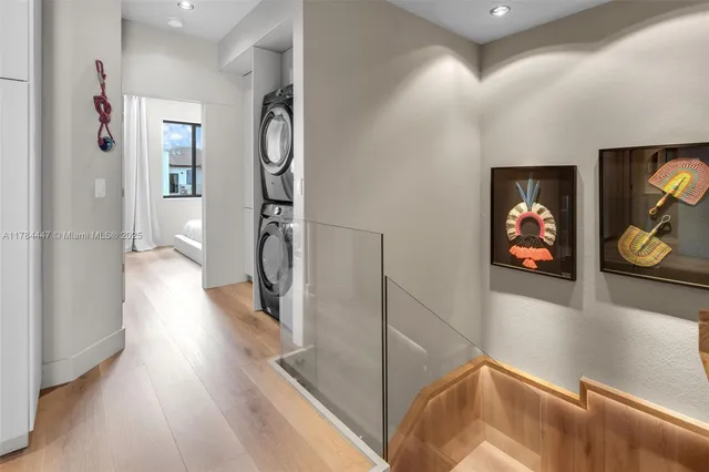 a view of hallway with stairs and wooden floor