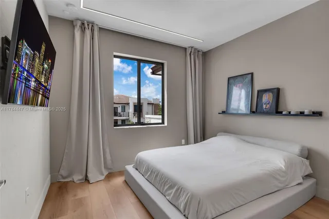 a bedroom with a large bed and a window