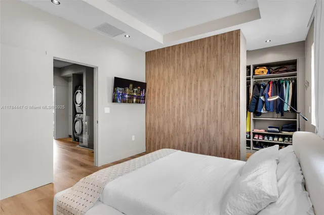 a bedroom with a bed and a book shelf