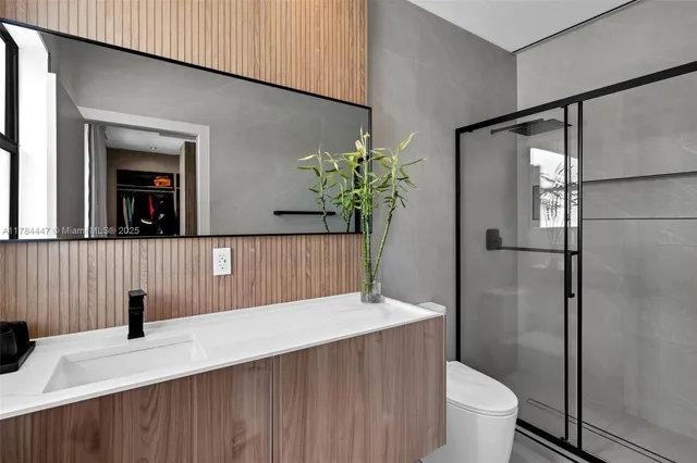 a bathroom with a sink toilet and shower