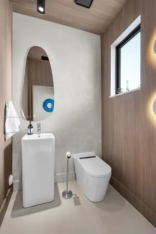 a bathroom with a sink toilet and mirror