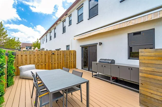 a balcony with table and chairs