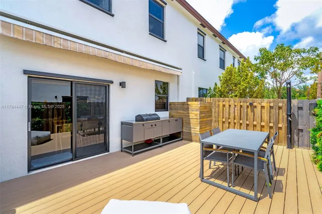 a view of a patio with a table and chairs