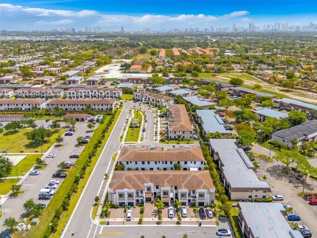 an aerial view of residential building and ocean