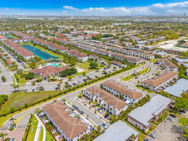 an aerial view of residential building and an ocean