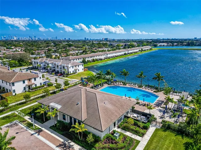 an aerial view of a house with a swimming pool outdoor seating and outdoor view