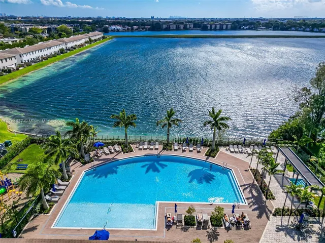 a view of swimming pool with outdoor seating and plants