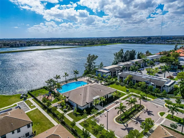 an aerial view of a house with a garden and lake view