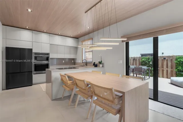 a kitchen with stainless steel appliances a sink stove and refrigerator