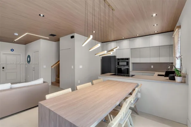 a large kitchen with a table and chairs in it