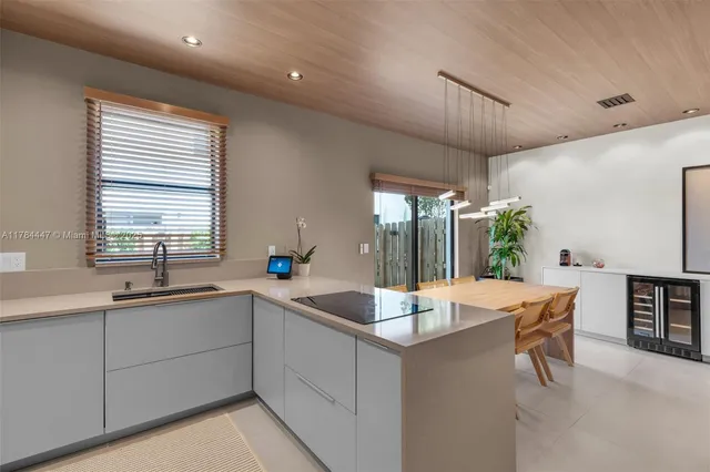 a kitchen with stainless steel appliances granite countertop a sink a stove and a refrigerator