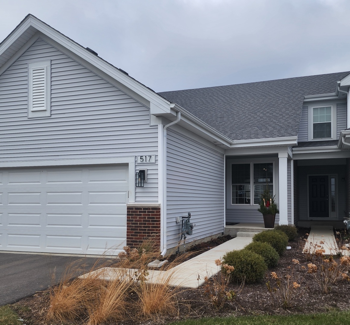 a view of a house with small yard and plants