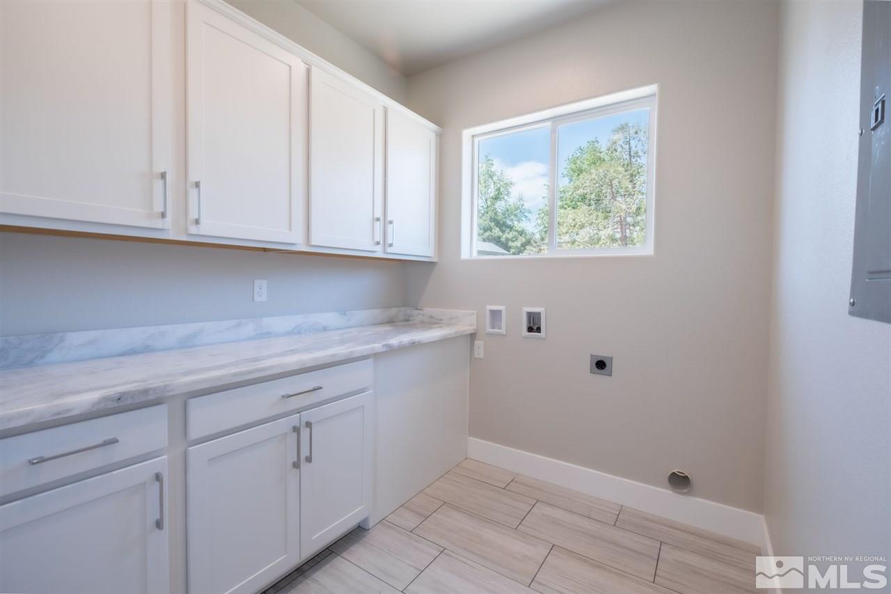 1605 Elizabeth Street Reno, NV 89509 - Photo 12 of 25 a kitchen with white cabinets and a window