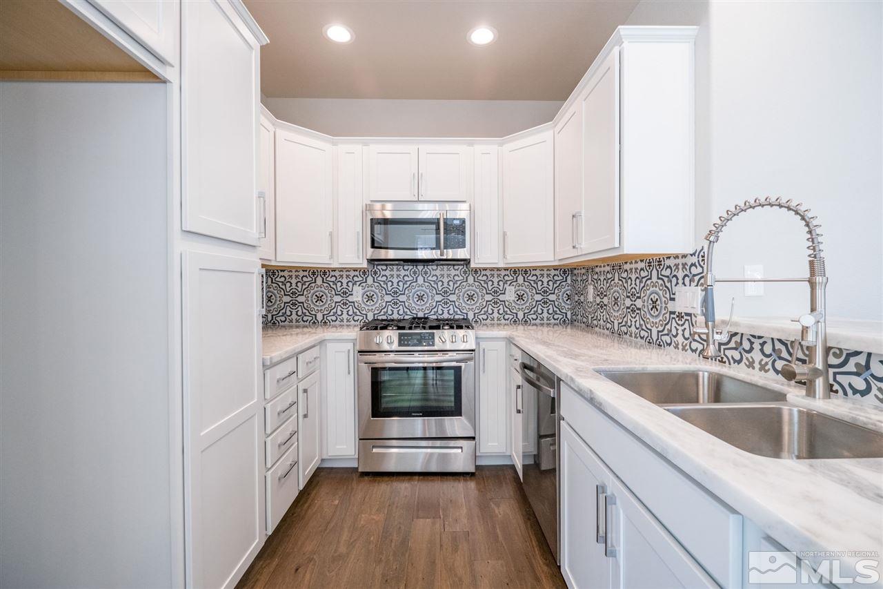 1605 Elizabeth Street Reno, NV 89509 - Photo 3 of 25 a kitchen with a sink cabinets and stainless steel appliances