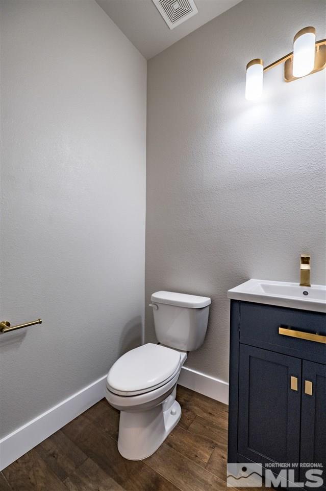 1605 Elizabeth Street Reno, NV 89509 - Photo 9 of 25 a white toilet sitting next to a bathroom sink