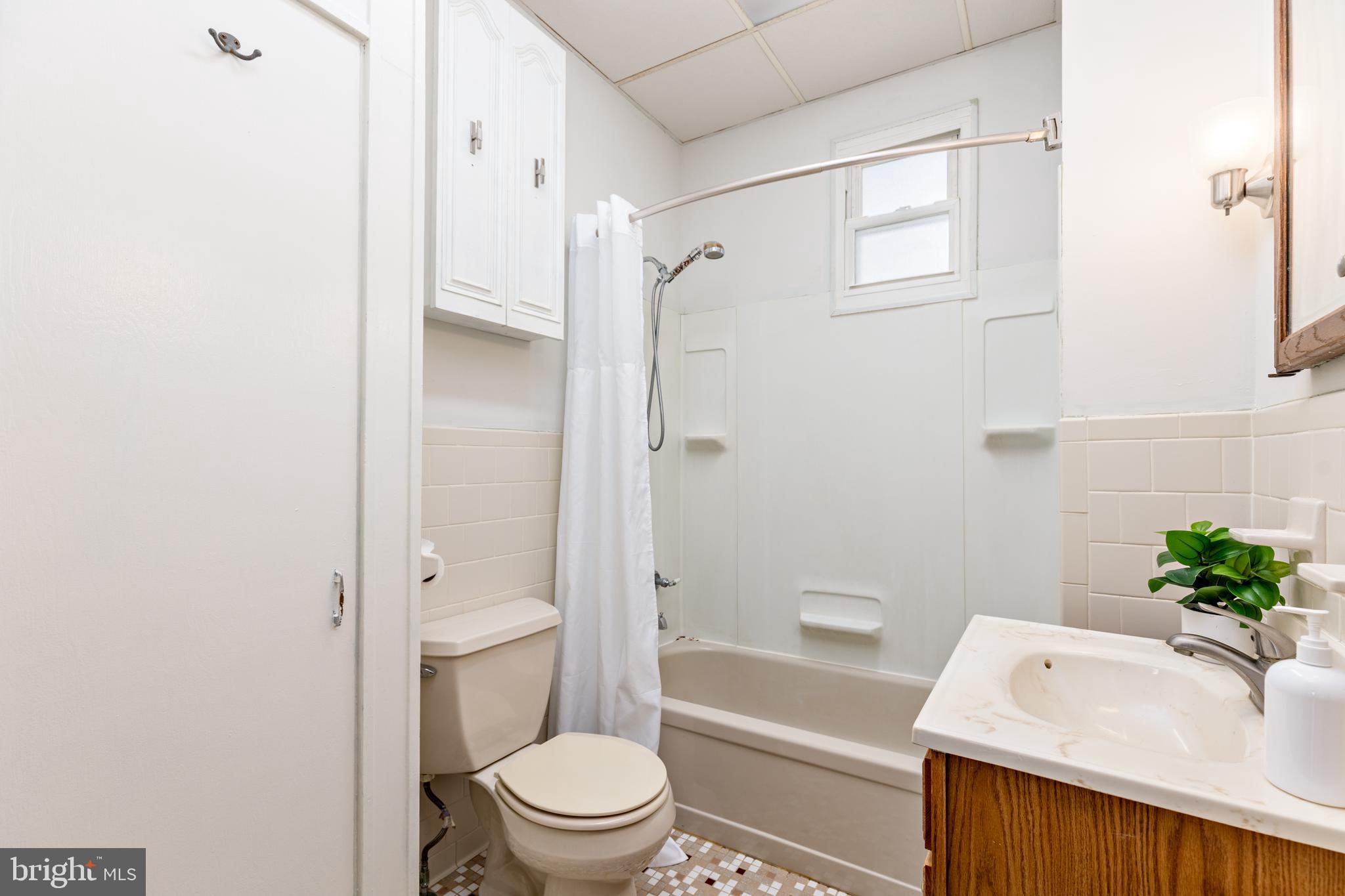 6426 Sherwood Road Baltimore, MD 21239 - Photo 20 of 43 a bathroom with a sink toilet and shower