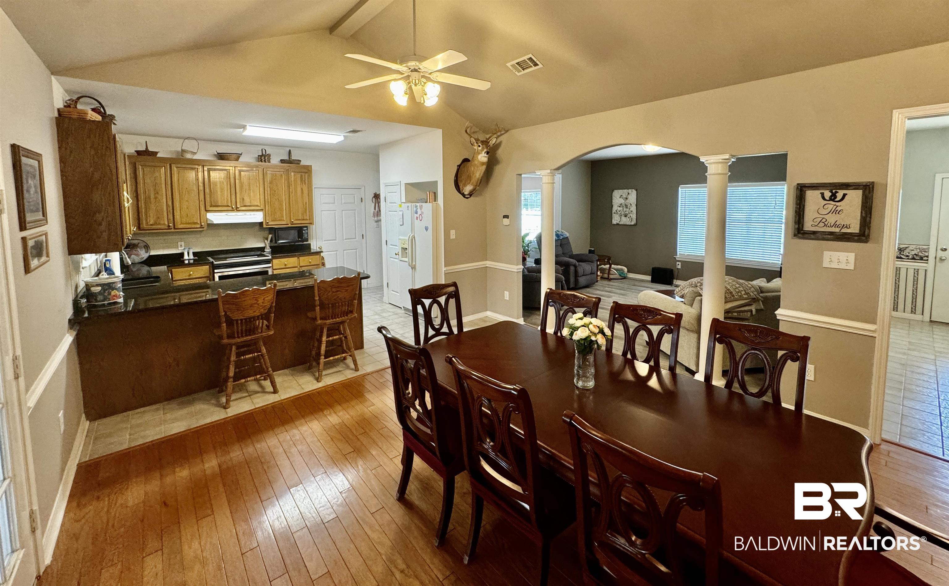 13795 White Road Silverhill, AL 36576 - Photo 26 of 99 Dining area with a ceiling fan, arched walkways, light wood-style flooring, beam ceiling, and decorative columns