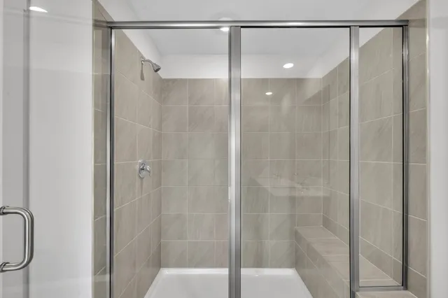 a bathroom that has a glass shower door