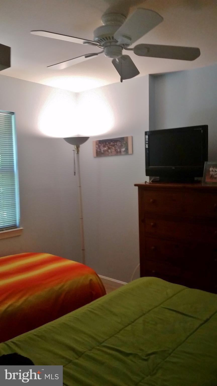 10452 Parthenon Court, Unit 10452 Bethesda, MD 20817 - Photo 11 of 13 a bedroom with a bed and a television