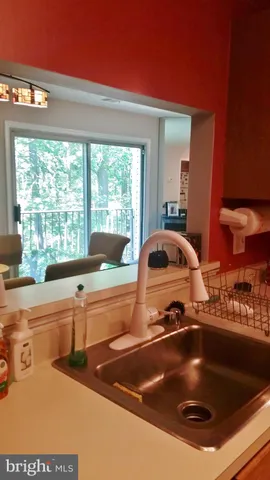 a kitchen with a sink and large window