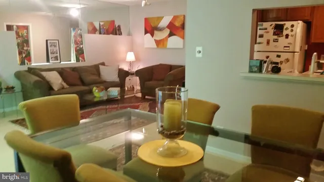 a living room with furniture and painting on the wall