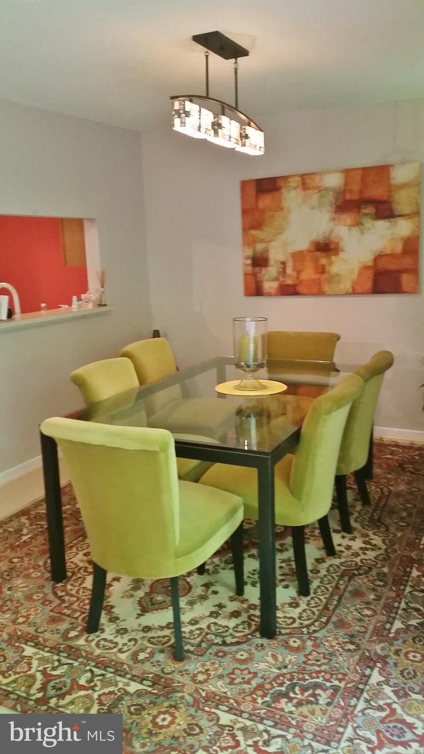 10452 Parthenon Court, Unit 10452 Bethesda, MD 20817 - Photo 5 of 13 a view of a dining room with furniture and wooden floor