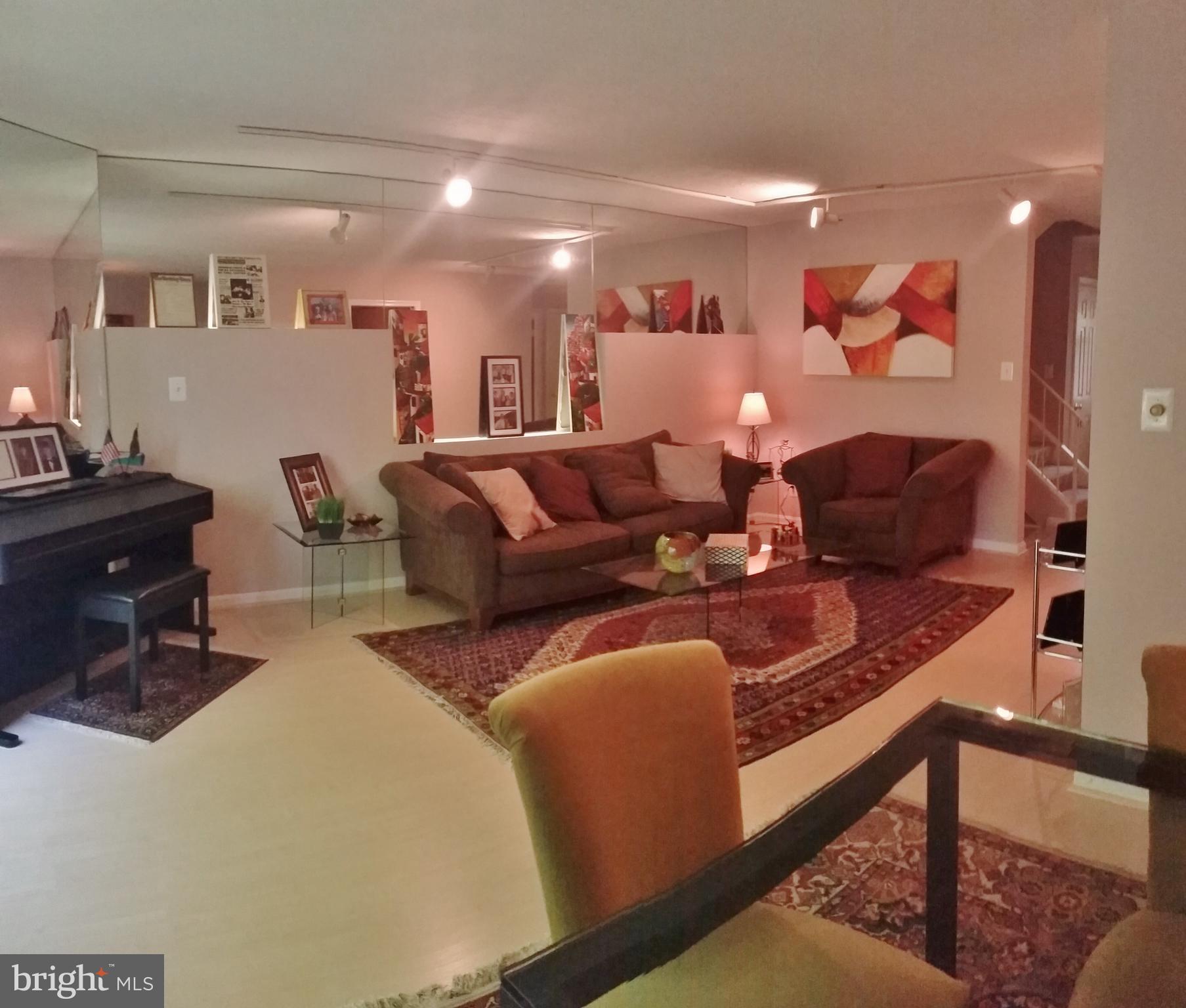 10452 Parthenon Court, Unit 10452 Bethesda, MD 20817 - Photo 6 of 13 a living room with furniture and wooden floor